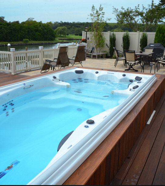 A partially recessed swim spa installation is an alternative to an in-ground pool