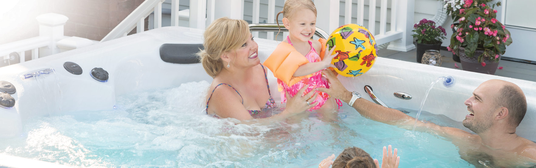 family enjoying an h2x fitness swim spa by master spas