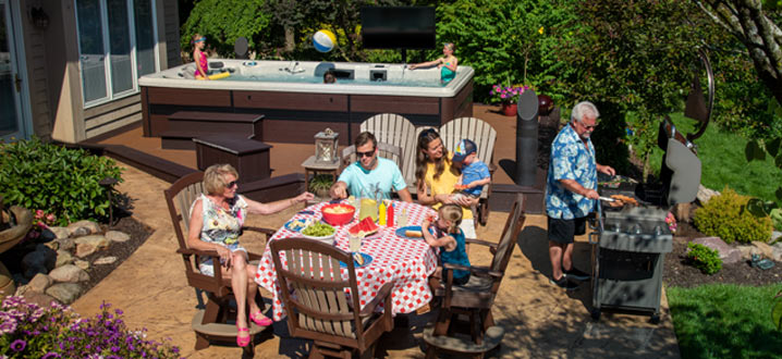 A family enjoying eating outside near a swim spa