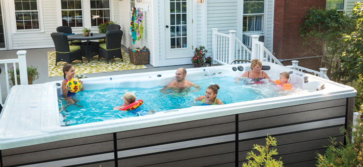an entire family enjoying a swim spa