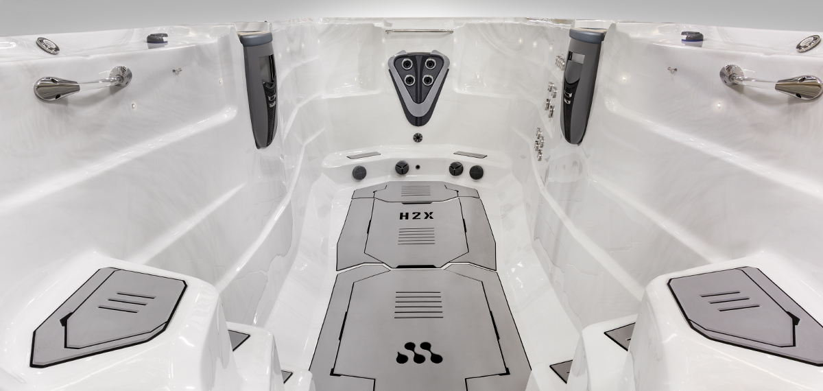 Inside view of a swim spa without water showing the Velocity Injector Plate.