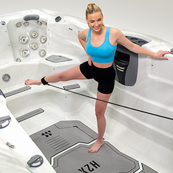 Woman using resistance bands in a swim spa.
