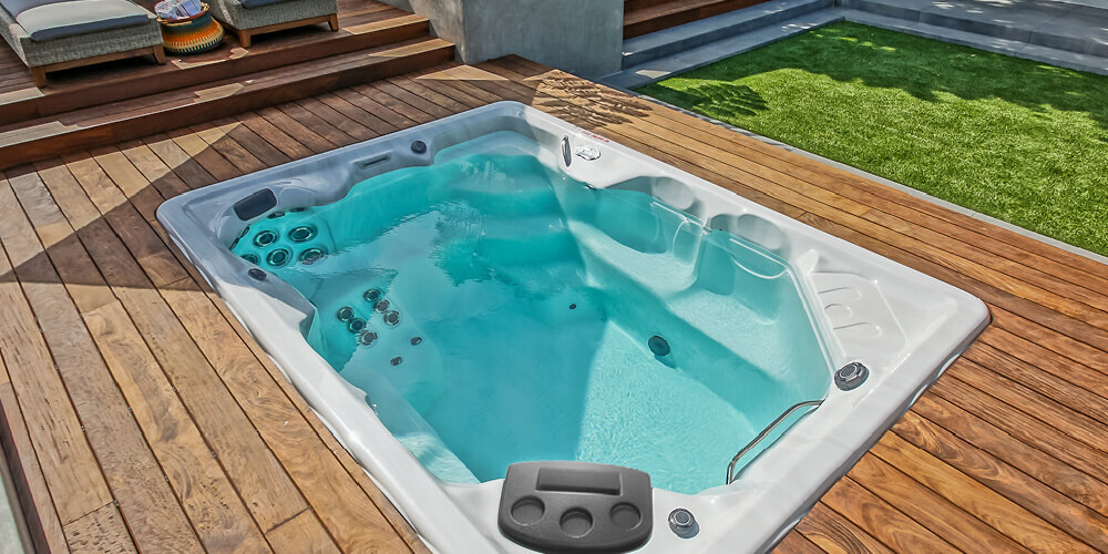 Privacy and your perfect backyard living space featuring a swim spa.