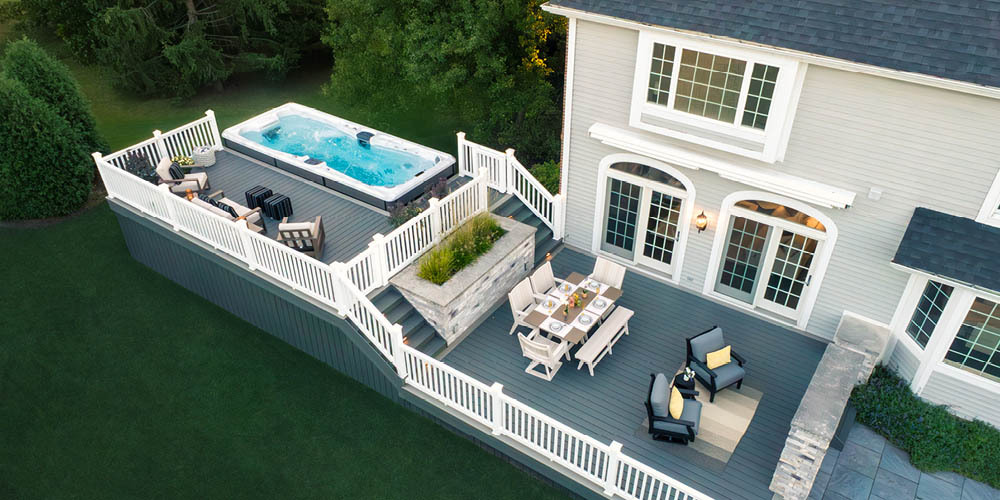 Aerial drone view of a swim spa installed next to a deck.