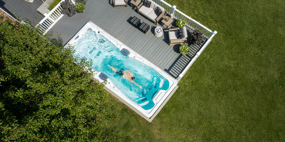 Drone view of someone swimming against the current in a swim spa.