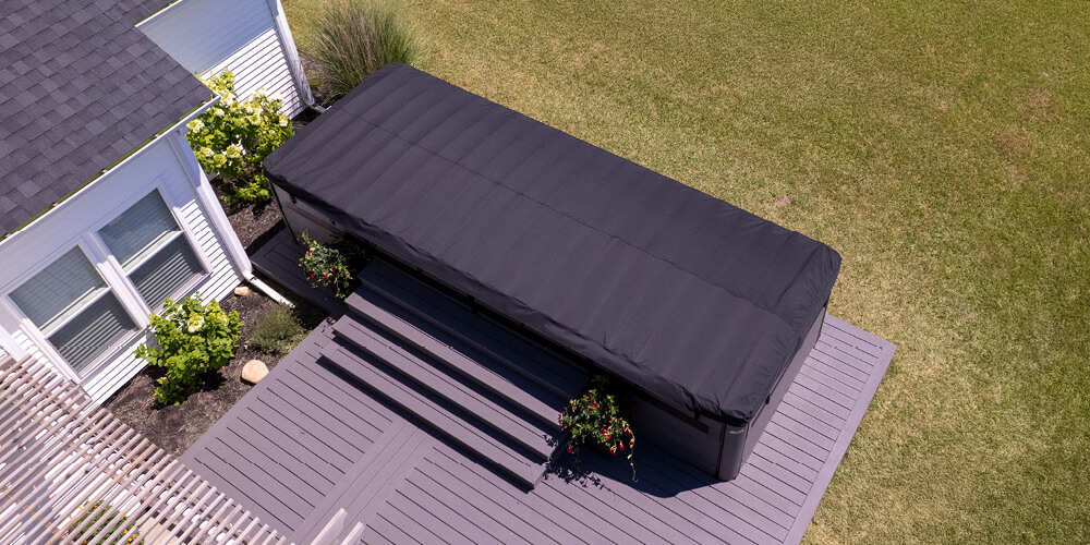 Aerial view of a cover on a swim spa on a backyard deck.