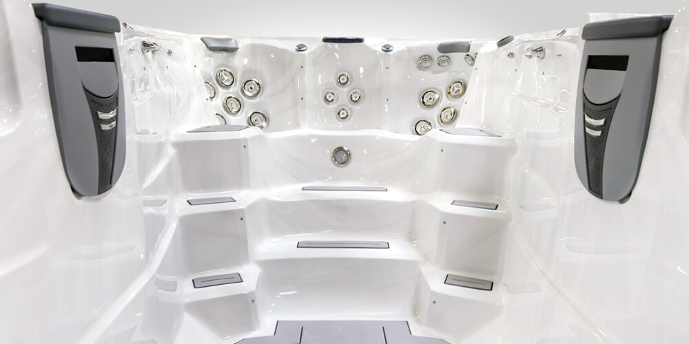 The steps on the inside of a swim spa with no water.